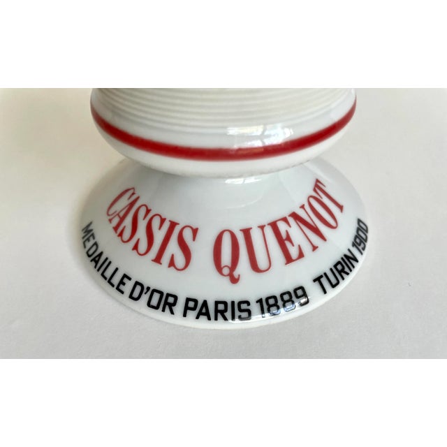 Here is a wonderful match striker made in France for the advertisement of Cassis Quenot wine and most likely used in a pub...