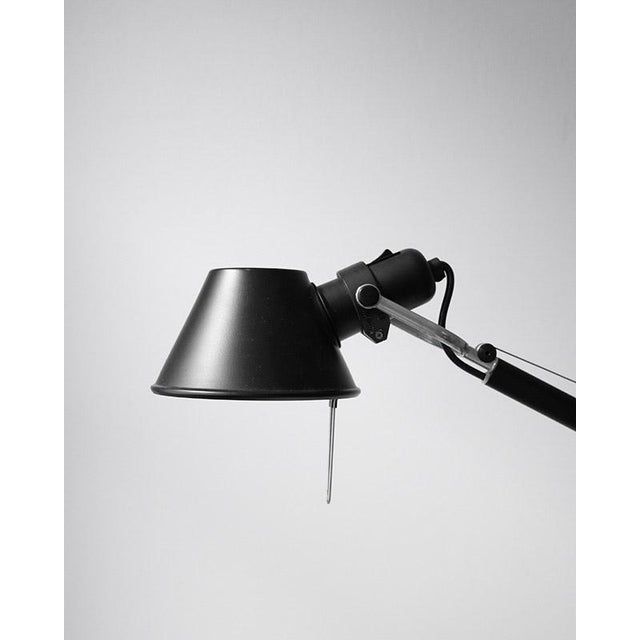 Iconic table lamp from the Italian brand Artemide, known for its functional design and adjustable construction. A...