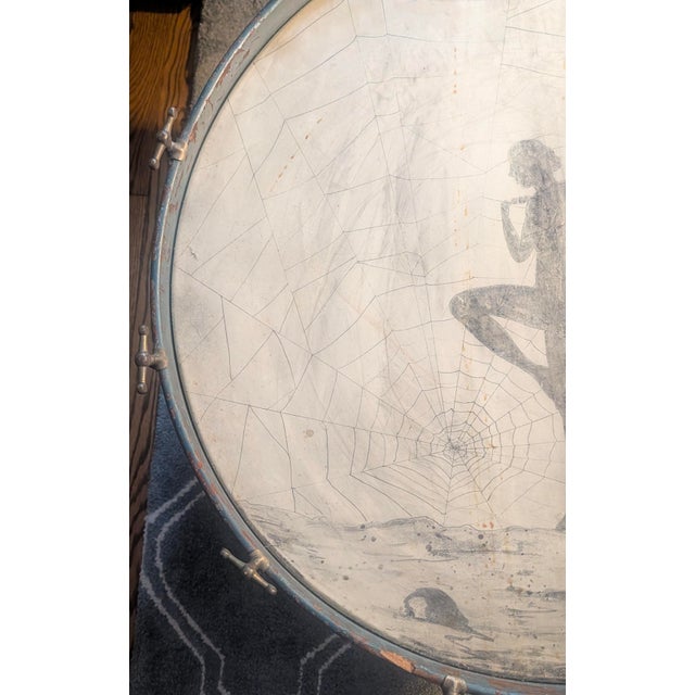 A striking, authentic early 20th-century Jazz Age bass drum featuring hand-painted illustration directly on the original...