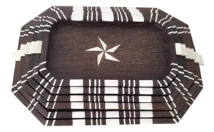 A stack of six antique wood trays with bone inlays