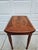 This beautiful one drawer Pembroke drop-leaf side table is by Baker Furniture and features an oval crotch mahogany veneer...