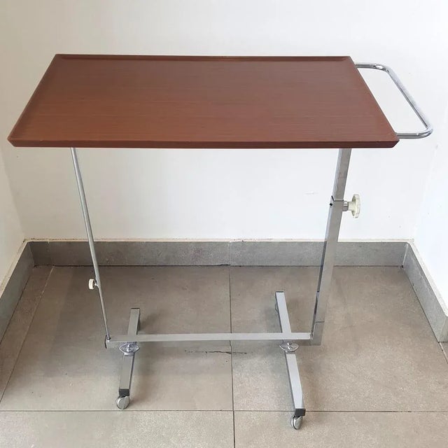 The side table is continuously adjustable in height from 66 to 97 cm: On the left the table is in the highest position of...