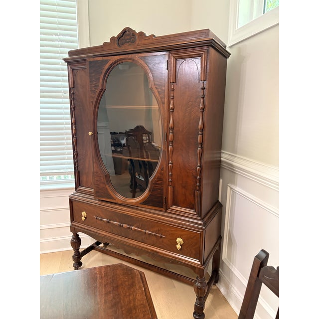 One of a kind beautiful antique Jacobean dining room china cabinet from the 1920s. Solid, walnut well-crafted piece with...