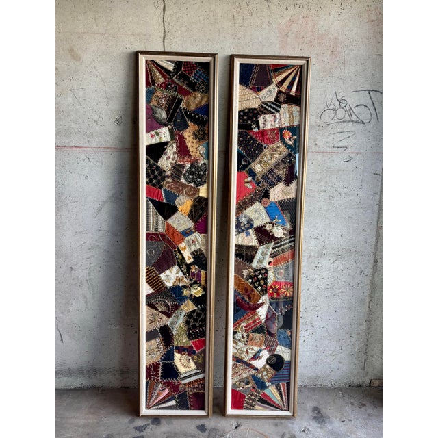 A striking and highly decorative pair of Victorian-style framed crazy quilts, presented as tall, architectural textile...