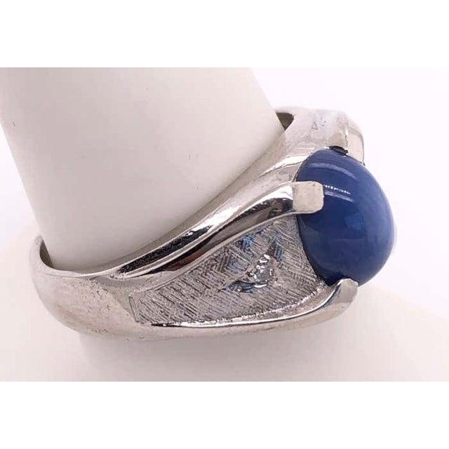 14 Karat White Gold Oval Sapphire Cabochon Ring with Diamond Accents 0.10 total diamond weight. Size 9 6.94 grams total...