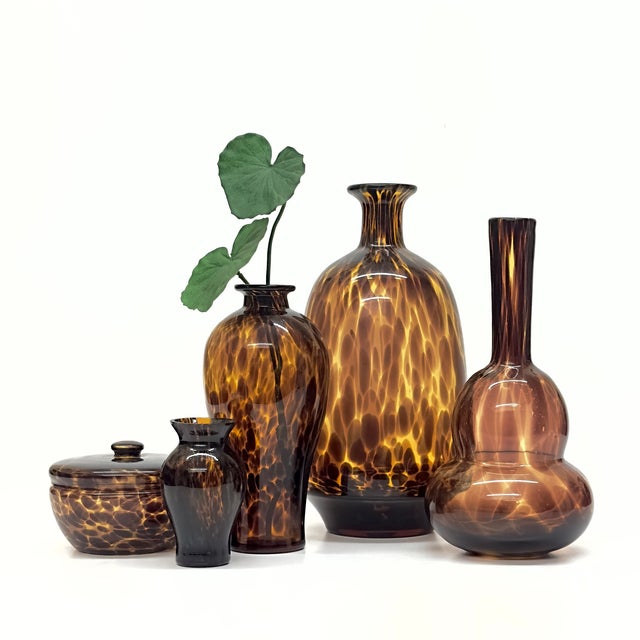 Assorted tortoise glass vessels, group of 5. A stunning group of amber-speckled tortoise glass vessels of assorted shapes...