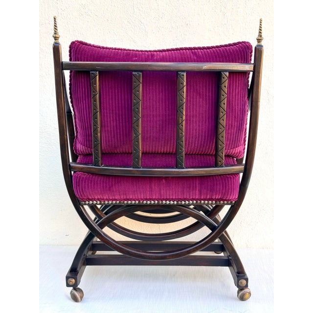 Vintage carved ebonized wood Savonarola arm chair on castors, newly upholstered with plush magenta velvet corduroy. Tight...