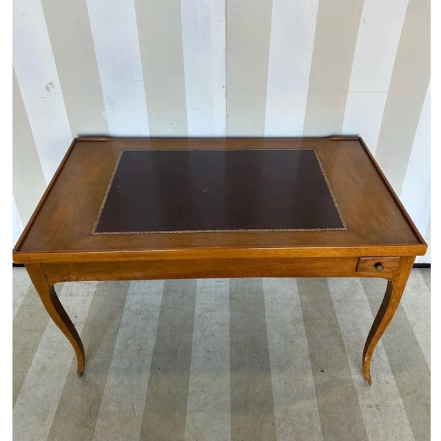 Fine 18th-century French walnut games table and leather-top writing desk. The table features a removable leather top that...