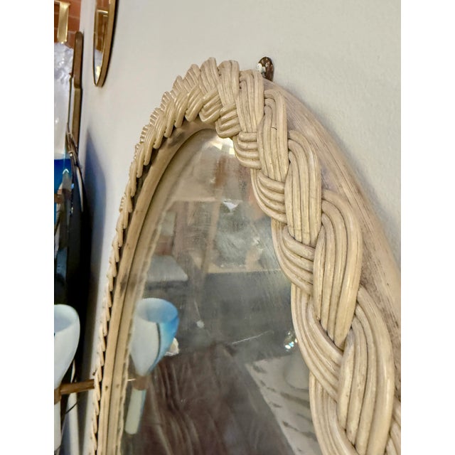 Italian oval mirror from the 1970s framed in an intricately braided rope design, a hallmark of coastal and nautical-...