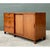 This credenza pairs solid, honey-toned wood with woven seagrass panels in a composition defined by clean, understated...