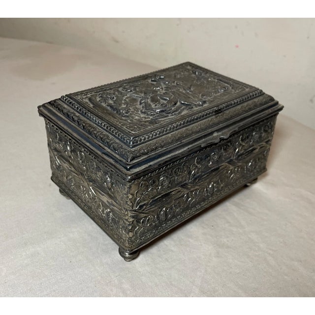 Experience the charm of the 19th century with this ornate silverplate wooden Swiss cylindrical music box, a treasure from...