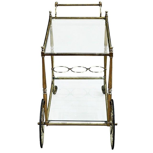 Mid-century era Hollywood Regency French Drinks Trolley crafted from solid bright brass work, the two-tier structure...