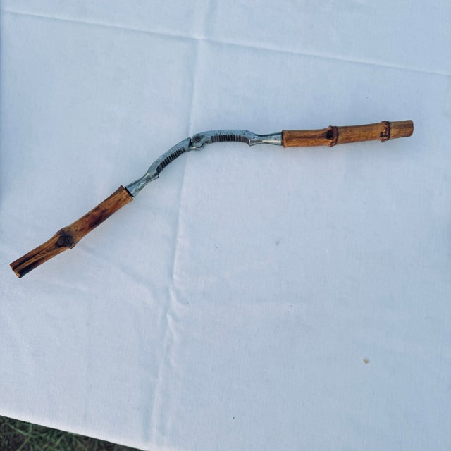 Vintage bamboo-handled and stainless steel nutcracker in great working condition.