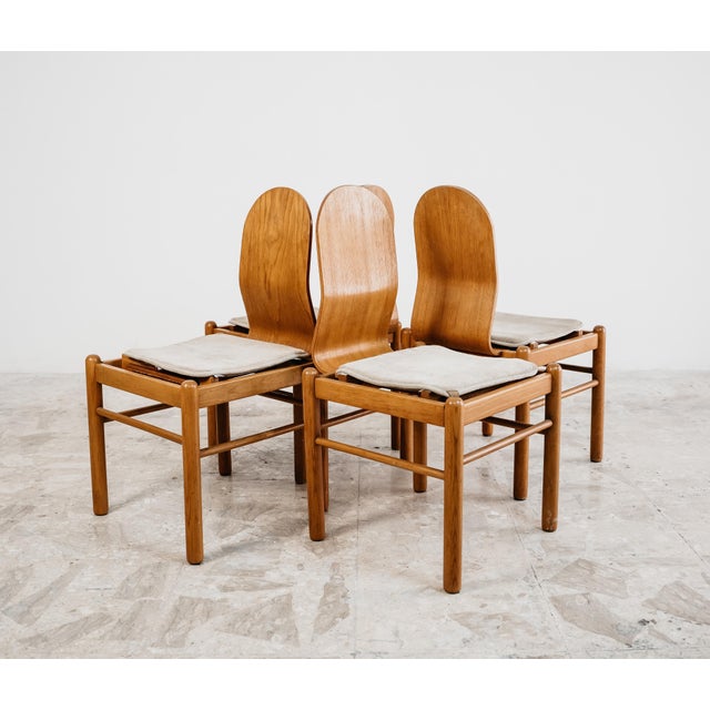 Set of four 1970s Scandinavian-style dining chairs, featuring clean lines, balanced proportions and a warm wooden essence...