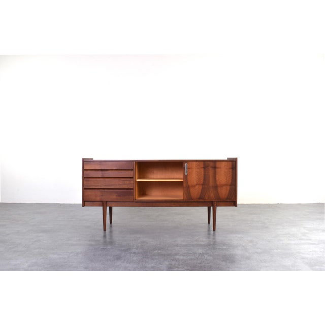 This sideboard was produced in Poland in the 1960s by Bytomskie Fabryki Mebli. The furniture is veneered with a beautiful...