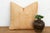 A repeating diamond medallion in crisp white ink covers the full face of this pillow, hand block-printed on golden mustard...
