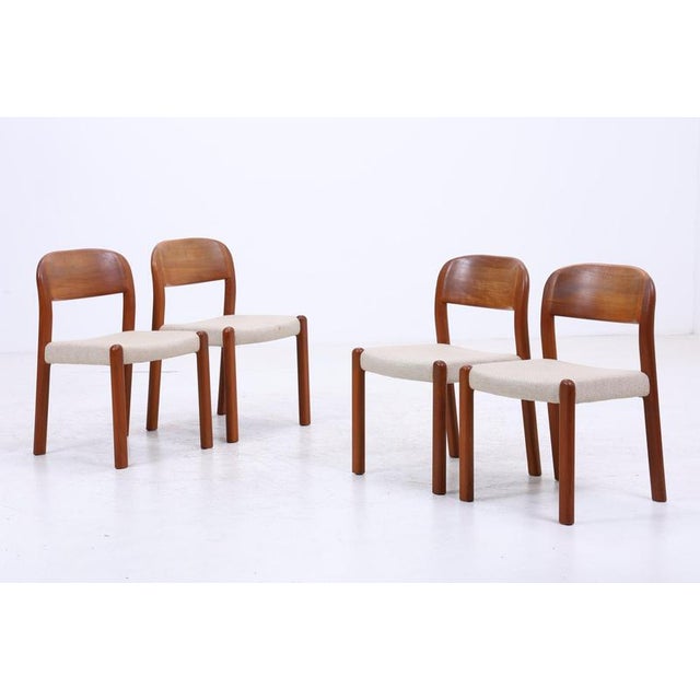 Vintage set of four Danish teak chairs by EMC Møbler, featuring harmoniously shaped backrests and pleasingly clean...