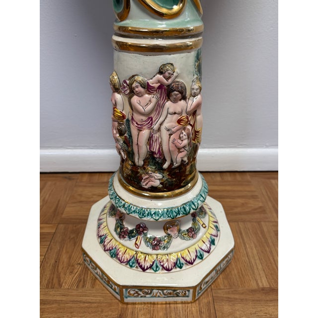 Elegant and highly decorative, this vintage Italian Capodimonte porcelain pedestal showcases the ornate craftsmanship the...