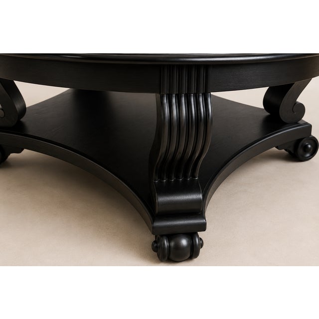 Elegant and timeless, this vintage round pedestal coffee table has been professionally refinished in a rich satin black...