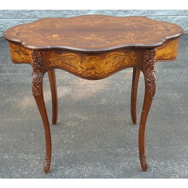 An Early 20th Century Louis XV Style Marquetry Mahogany Inlaid Center Table with some Mother-of-Pearl inlays Measures 38"...