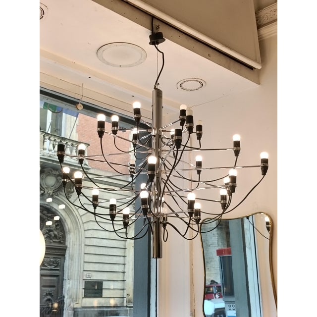 The Flos Model 2097 30-light chandelier was designed by the renowned designer Gino Sarfatti and is a perfect embodiment of...