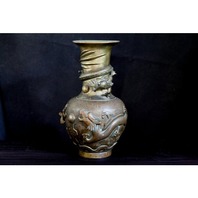 Spitting dragons and other sea creatures with archaic symbology powerfully wrap around this urn. Wonderful vintage patina....