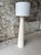 Striking vintage floor lamp inspired by classical Greek column architecture, featuring a tall tapered pedestal base,...