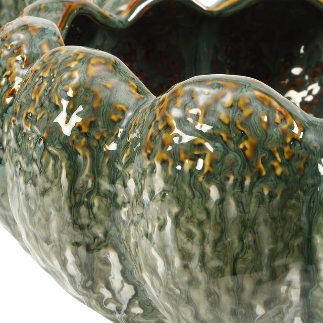 Handmade ceramic bowl featuring a beautifully organic, scalloped form and a richly variegated glaze in layered shades of...