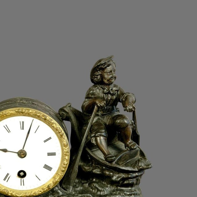 A charming and highly decorative French figural mantel clock dating from the late 19th century, combining sculptural...