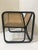 Large armchair in rattan and caning; structure in curved rattan and black lacquered, caned backrest, clean and airy lines.