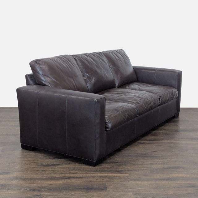 This Room and Board sleeper sofa features rich dark brown leather and roomy seating for three. Its classic, clean design...