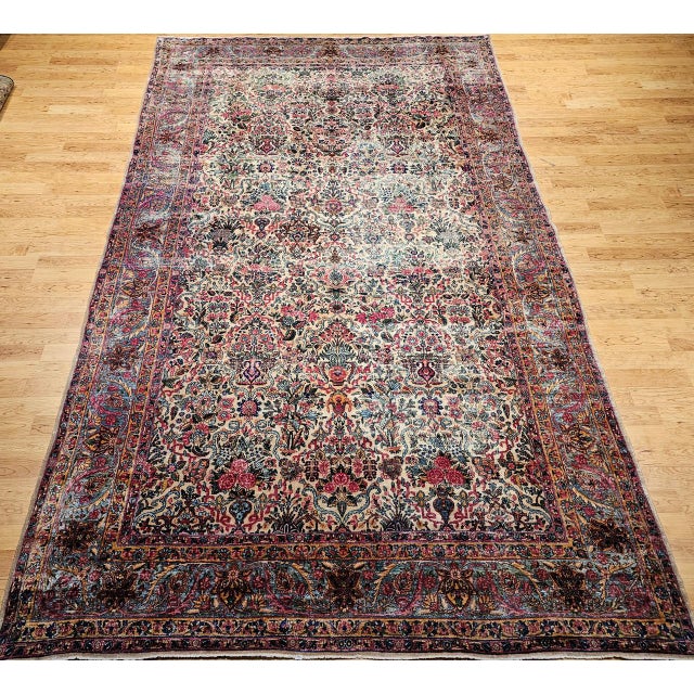 Early 20th century oversize Persian Kerman Lavar in an allover floral pattern. This rug features a graceful and peaceful...