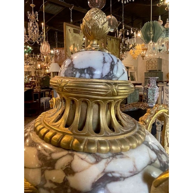 The product listed is a pair of 19th century French marble and bronze cassiolette urns. These decorative collectibles...