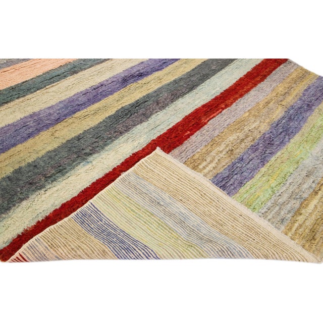 Beautiful modern Tulu hand-knotted wool rug with a multicolor field. This Tulu rug has a gorgeous all-over striped design....