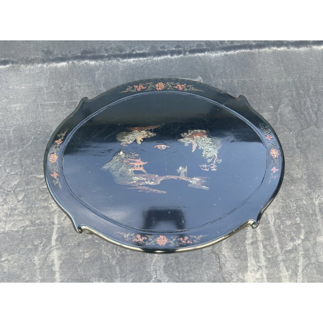 Lovely chinoiserie table in black lacquer with hand painting throughout. Cabriole legs with some carving to tops of legs...
