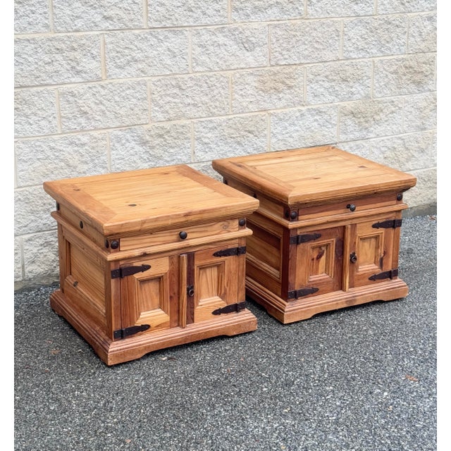 A pair of solid pine nightstands made in Mexico. Featuring warm wood tones, sturdy construction, and wrought iron...