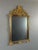 Elegant Louis XV style wall mirror in richly carved and gilded wood, dating from the 20th century. The frame features a...