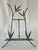 Vintage faux bamboo folding picture easel holds framed artwork. Crafted of metal and painted in a bamboo green color.
