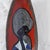Ceramic piece decorated using the sgraffito technique, depicting a young woman in black, blue, yellow, and green enamel on...