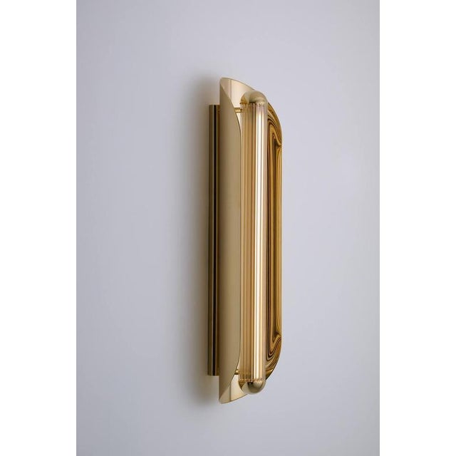 Oblong silex cannelé wall lamp by jennifer midoz dimensions: d 15 x w 12 x h 60 cm materials: pale gold on polished brass...