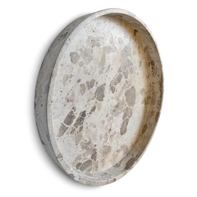Solid marble tray bowl featuring a blend of soft white and warm beige tones, complemented by the natural veining and...