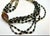 Multi-strand seven strand necklace, pairing jet-black bar/rectangular tube beads, mirror-finish gunmetal glass rectangles,...