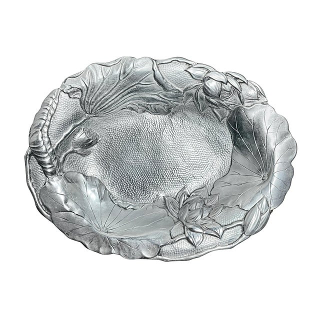 A Japanese sterling silver dish from the Meiji period. Shallow dish with finely cast lily pads and lotus flowers on a...