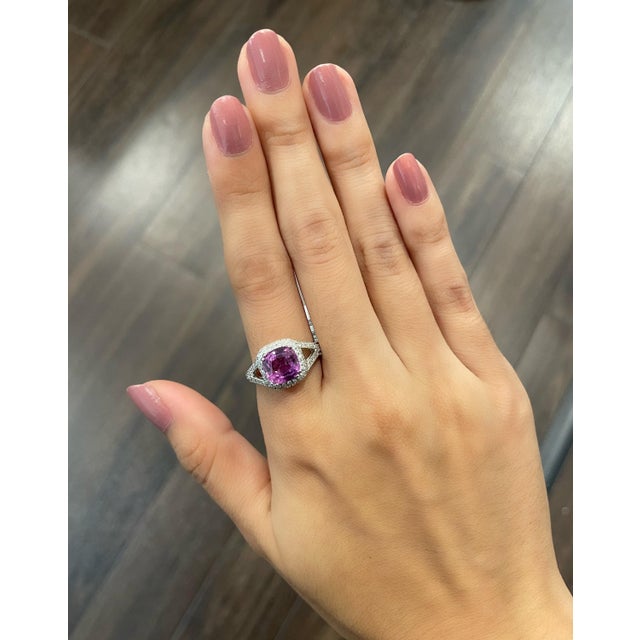 Check out this gorgeous 18k white gold ring set with a natural pink sapphire weighing 2.55 ct. Surrounding the pink...