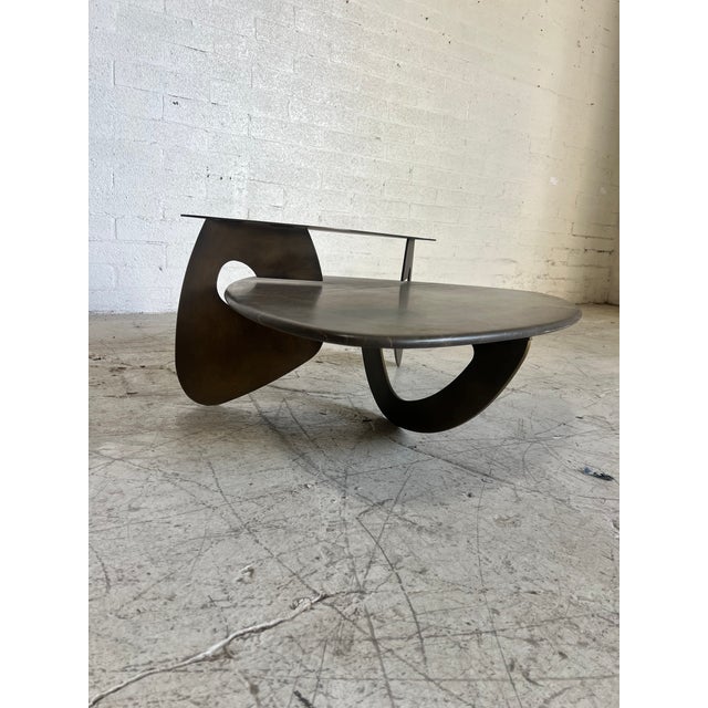 Unique custom 2-piece coffee table featuring a metal modernist design and "floating" piece of (heavy) stone in the shape...