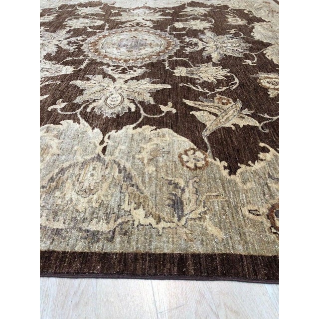 This hand knotted pile rug is a brown earth tone Agra rug made from natural wool. It serves as a classic traditional floor...