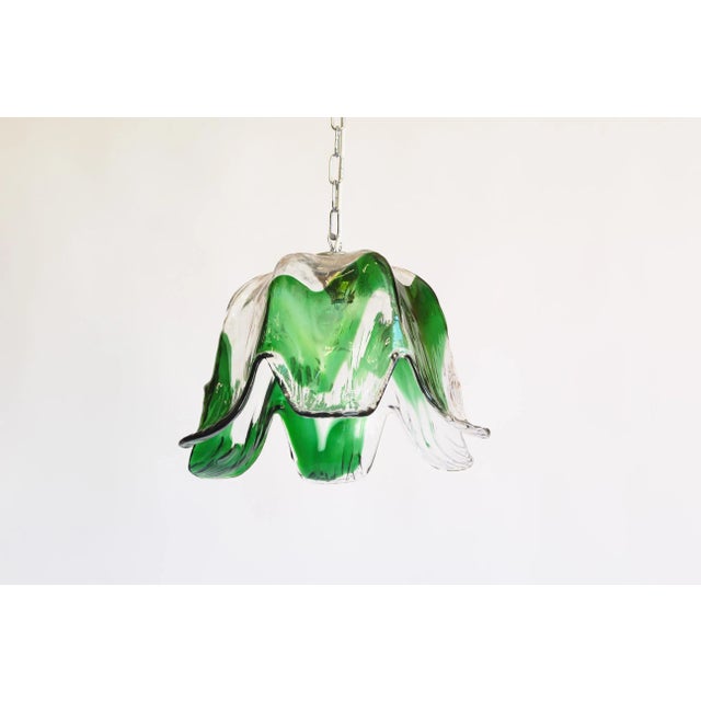Spectacular vintage 1970’s pendant chandelier by Mazzega Chrome metal frame holding a heavy Murano glass presenting the...