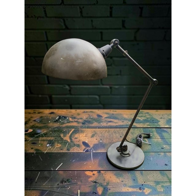 An original midgard ba 900 industrial articulated lamp, manufactured in east germany. The original label with the...
