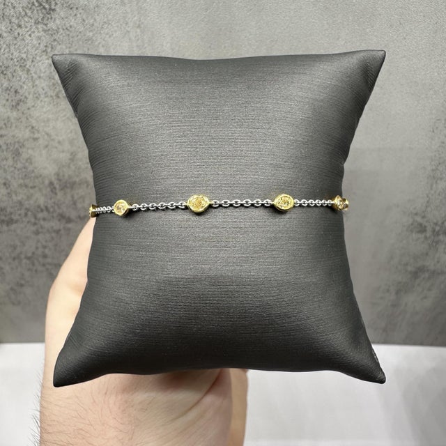This stunning Natural Yellow Diamond Station Bracelet in 14kt two-tone gold features 1.04ctw of natural fancy yellow VS...