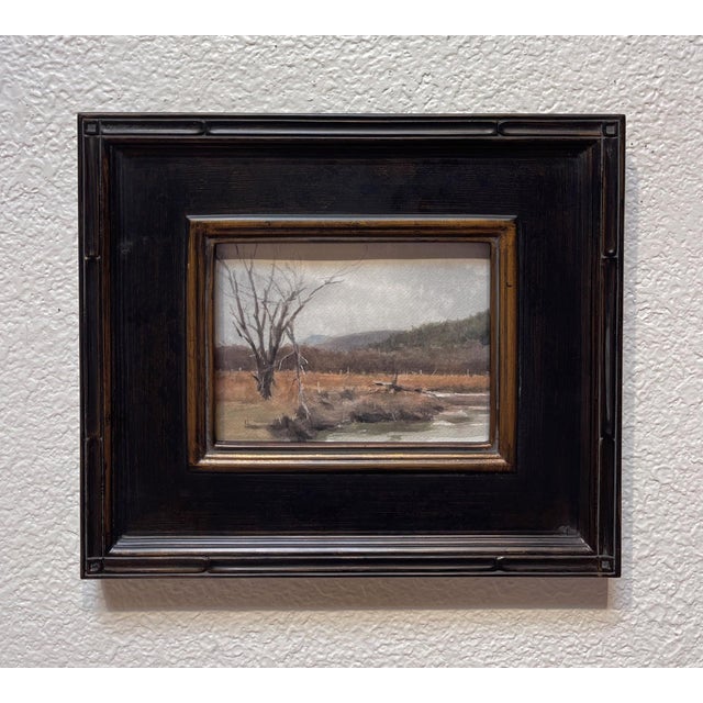 Where the River Runs captures a tranquil riverside scene, where a solitary tree stands against a backdrop of rolling hills...
